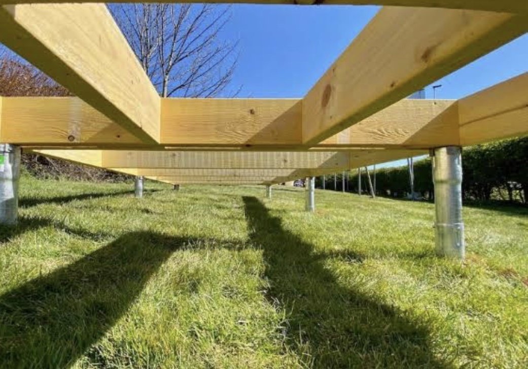 Timber floor frame on ground screws over grass