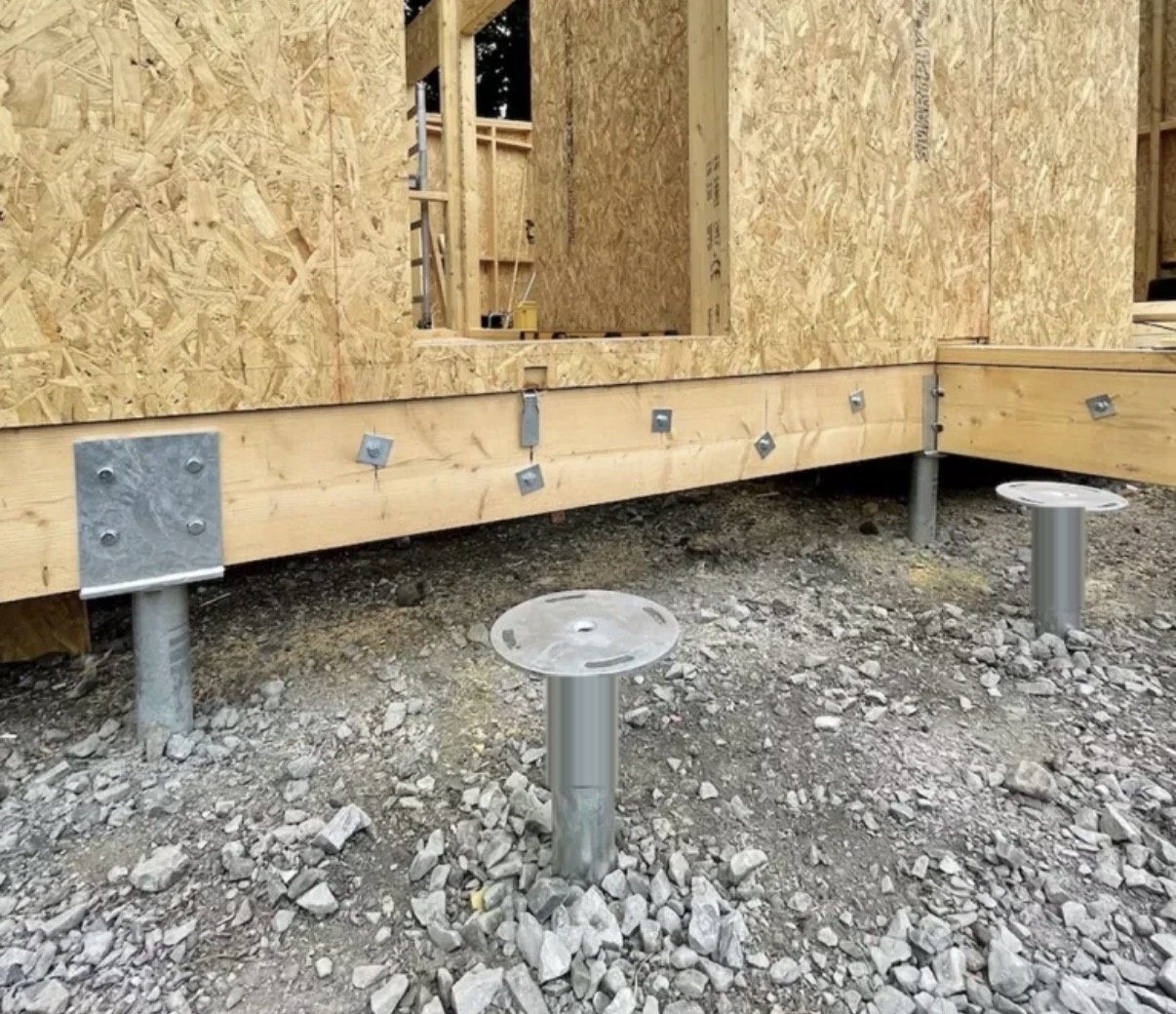 SIP panel walls on a timber base set on ground screws over gravel