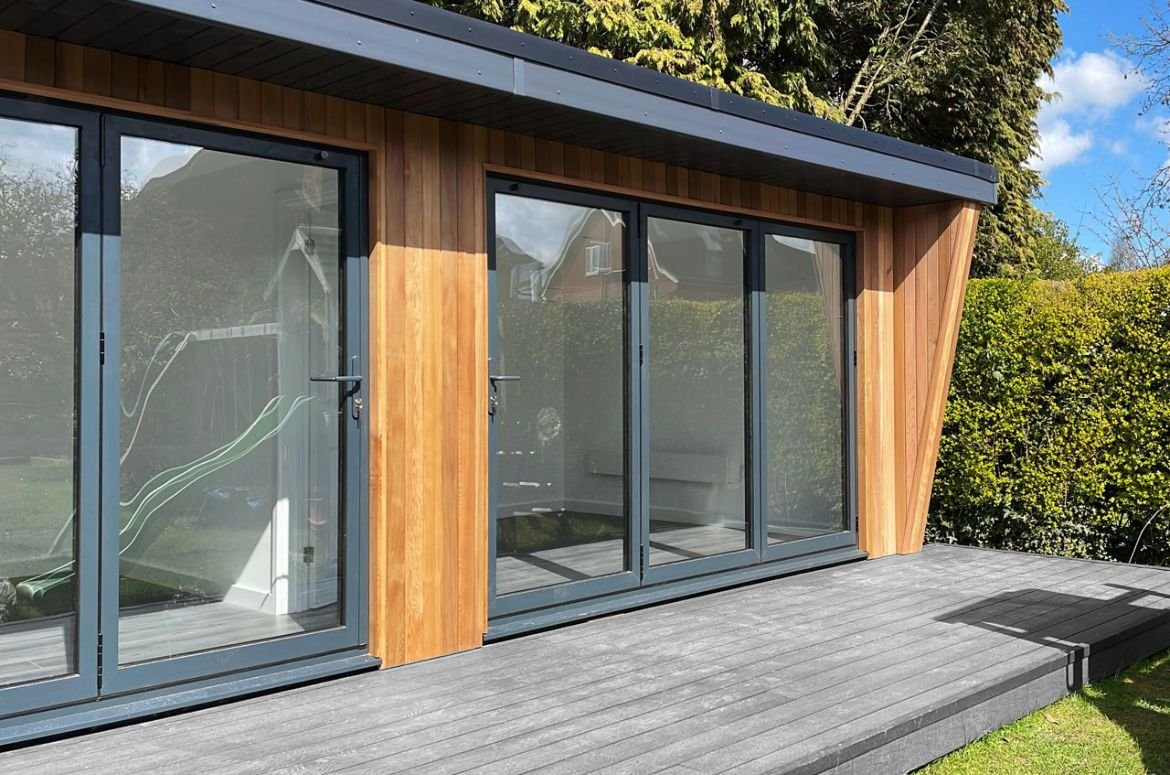 Cedar-clad garden room with two sets of bi-fold doors