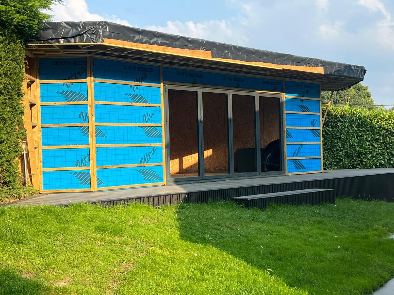 Garden room SIP kit wrapped in breather membrane before cladding