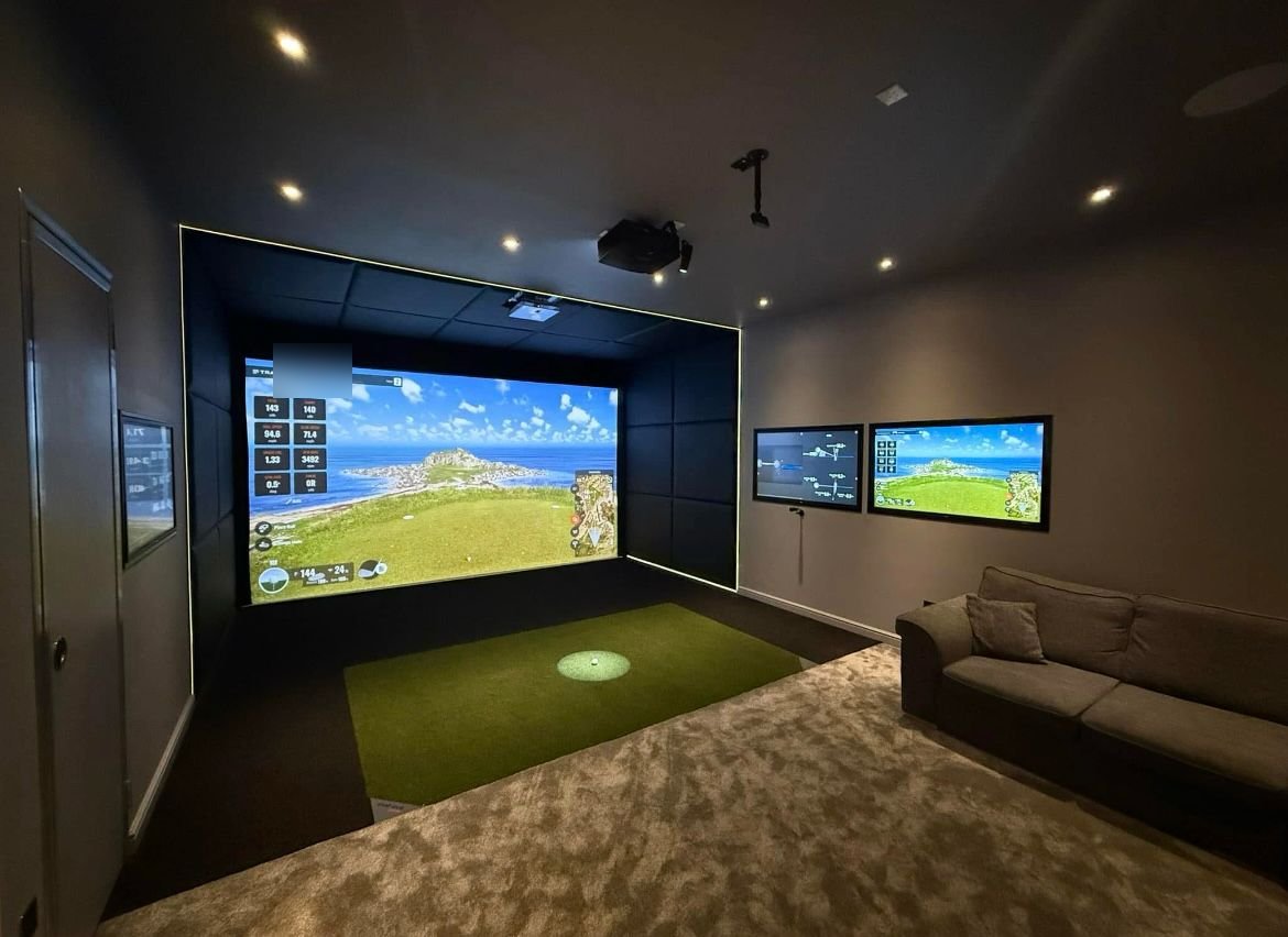 Finished golf simulator room with lounge seating