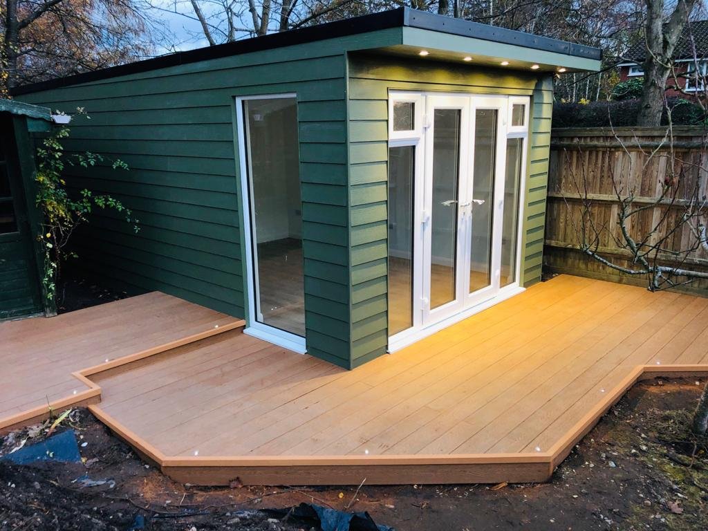 Green-clad garden room with composite deck at dusk