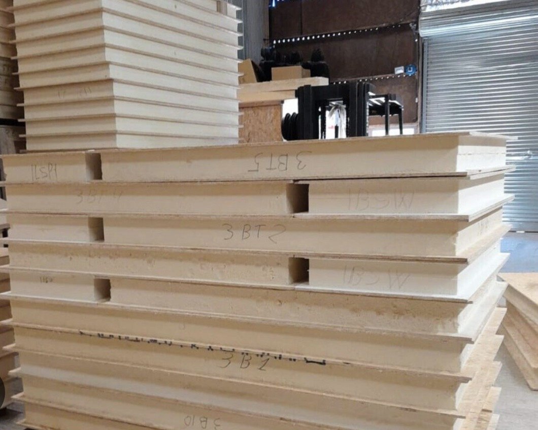 Close-up of stacked, labelled SIP panels with spline slots