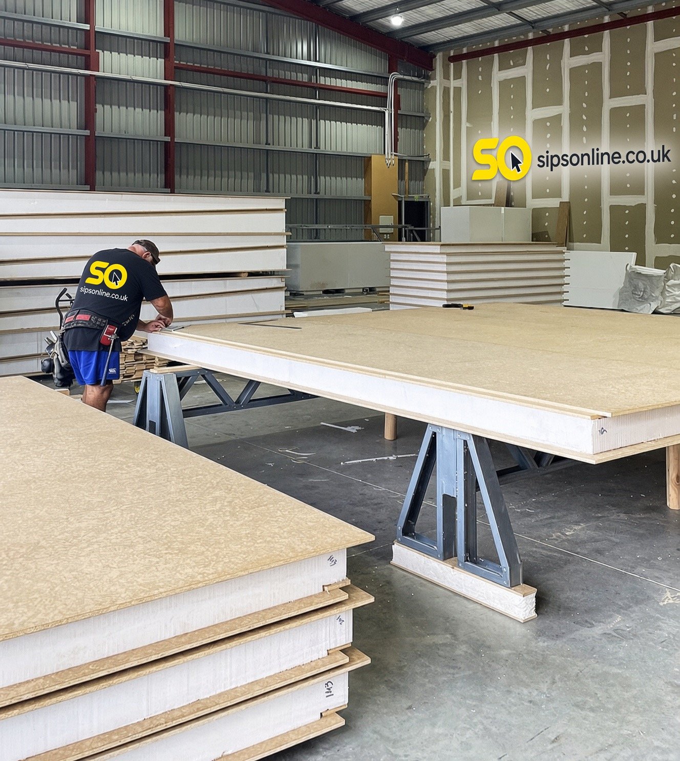 sipsonline worker marking out a SIP panel on trestles in the factory